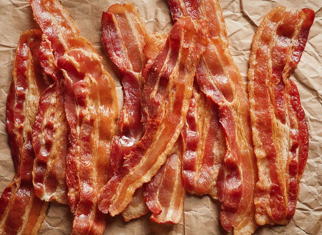 strips of cooked bacon lying on brown parchment paper