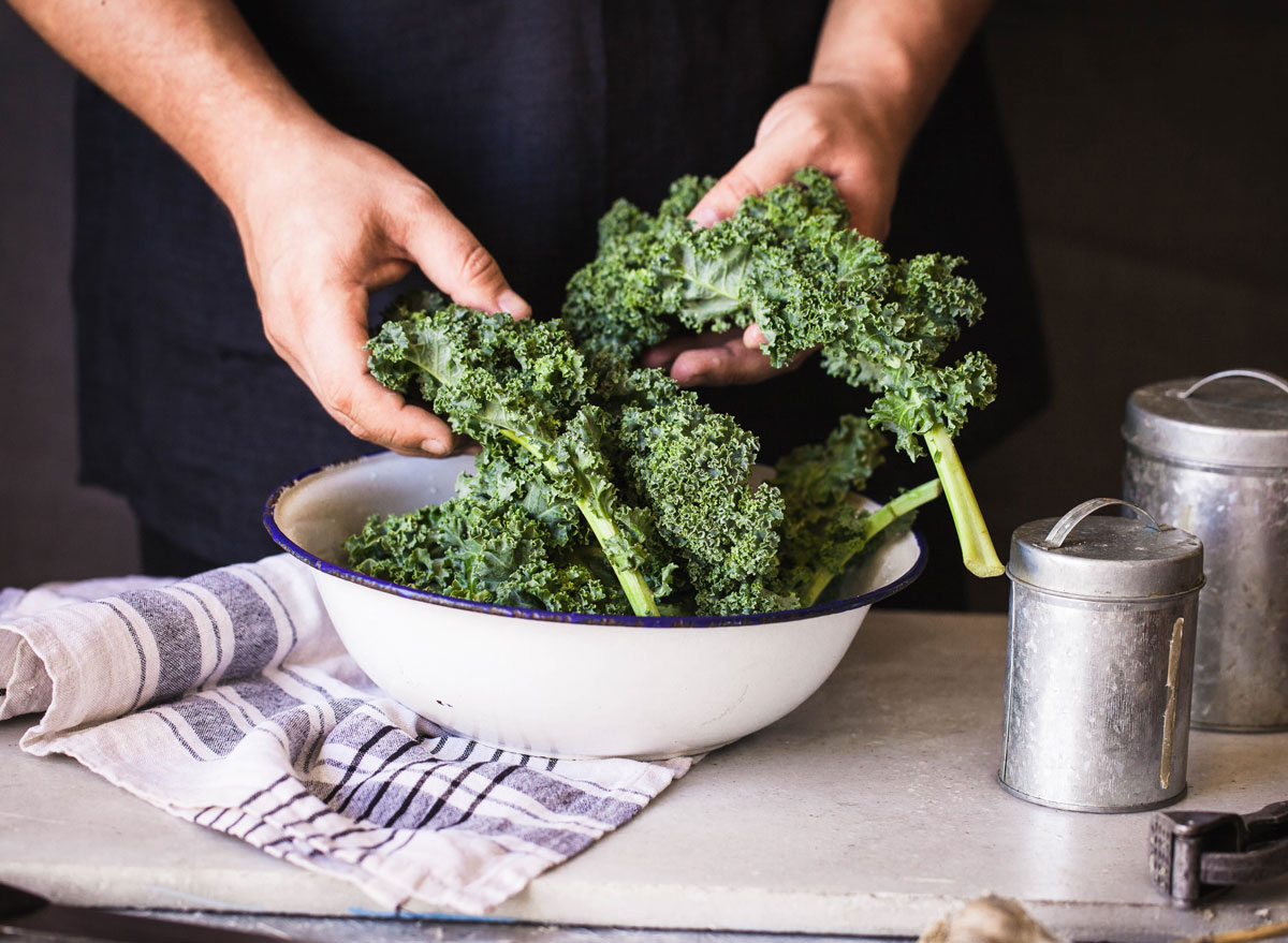 Kale dark leafy greens hand massaged in bowl - endometriosis diet