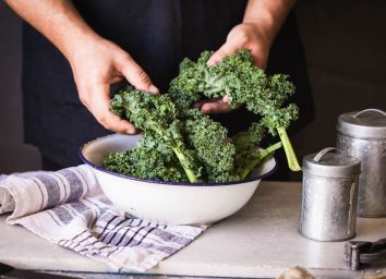Kale dark leafy greens hand massaged in bowl