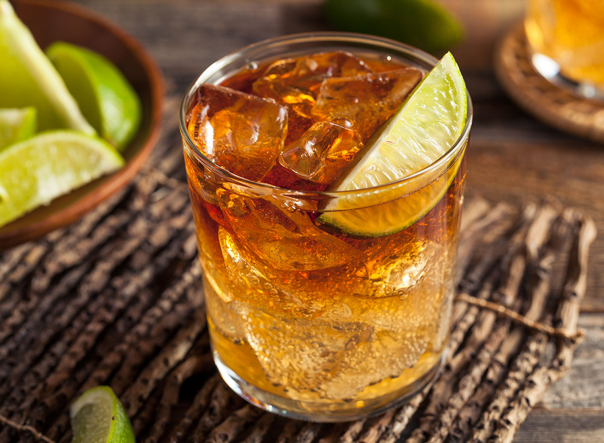 dark n stormy cocktail in glass with lime garnish