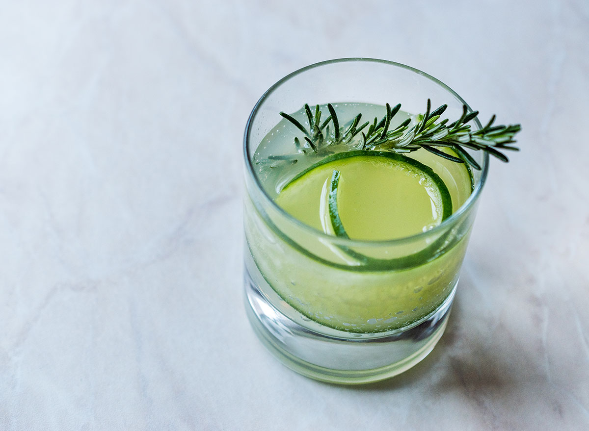 gimlet cocktail in glass with cucumber garnish