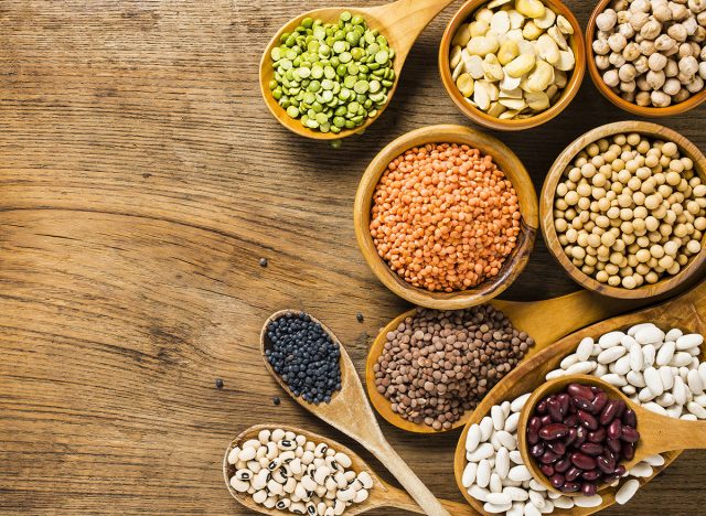 Different types of legumes and beans on different spoons