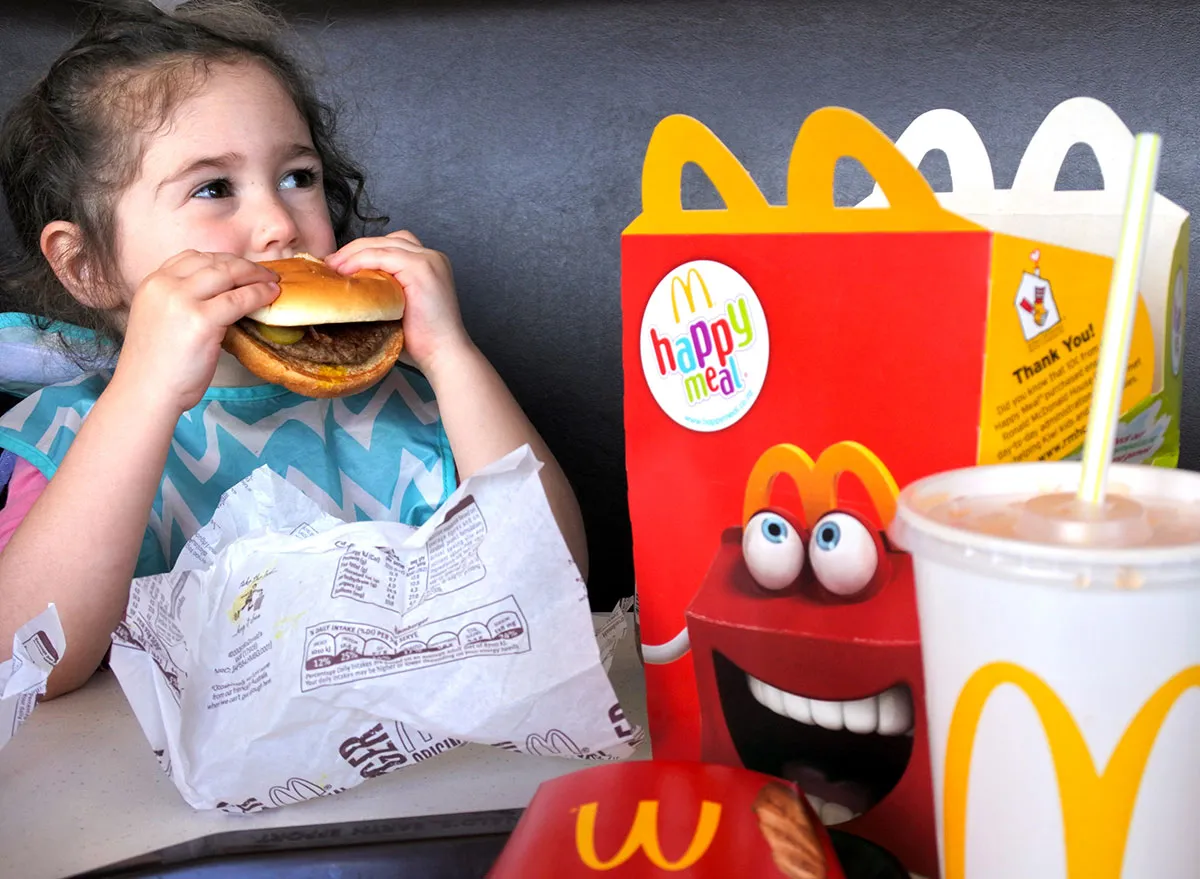 little girl eating mcdonalds