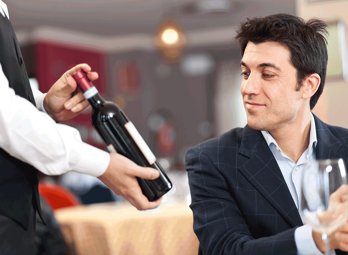 man thinking of buying wine