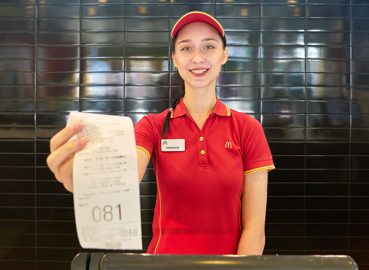 mcdonalds worker handing receipt