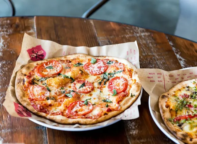 mod pizza with tomatoes on metal tray