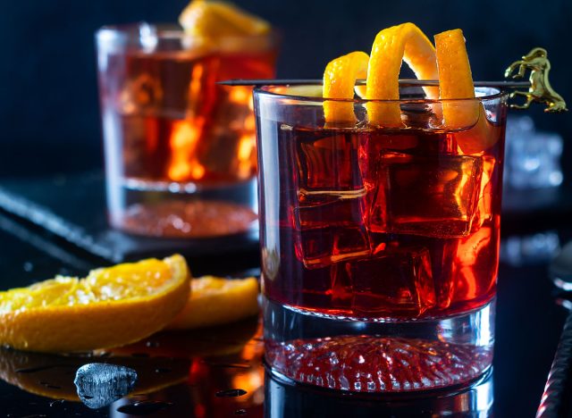 negroni cocktail glass with orange peel garnish