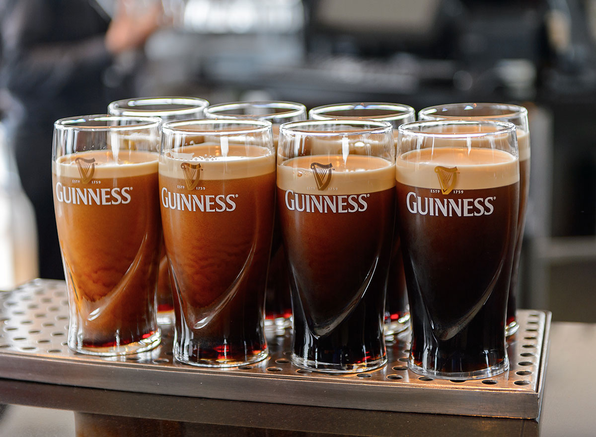 8 poured guinness in 8 glasses