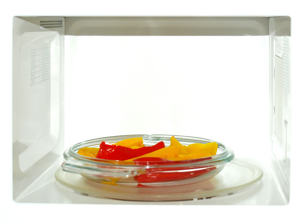 red yellow peppers on plate in microwave