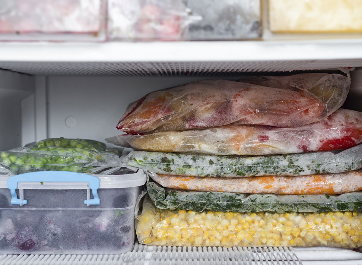 stacked old food on freezer shelf