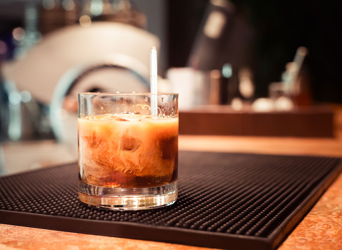 white russian stirred in glass on bar