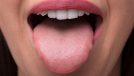 Woman sticking tongue out of mouth