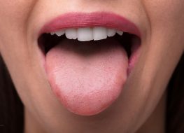 Woman sticking tongue out of mouth