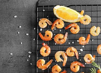 grilled shrimp on cooling rack with lemon wedge and sea salt