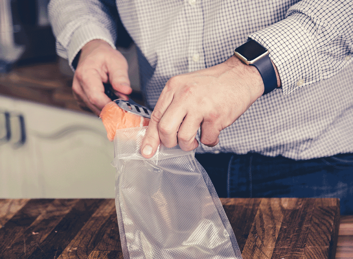 man storing salmon filet with tongs