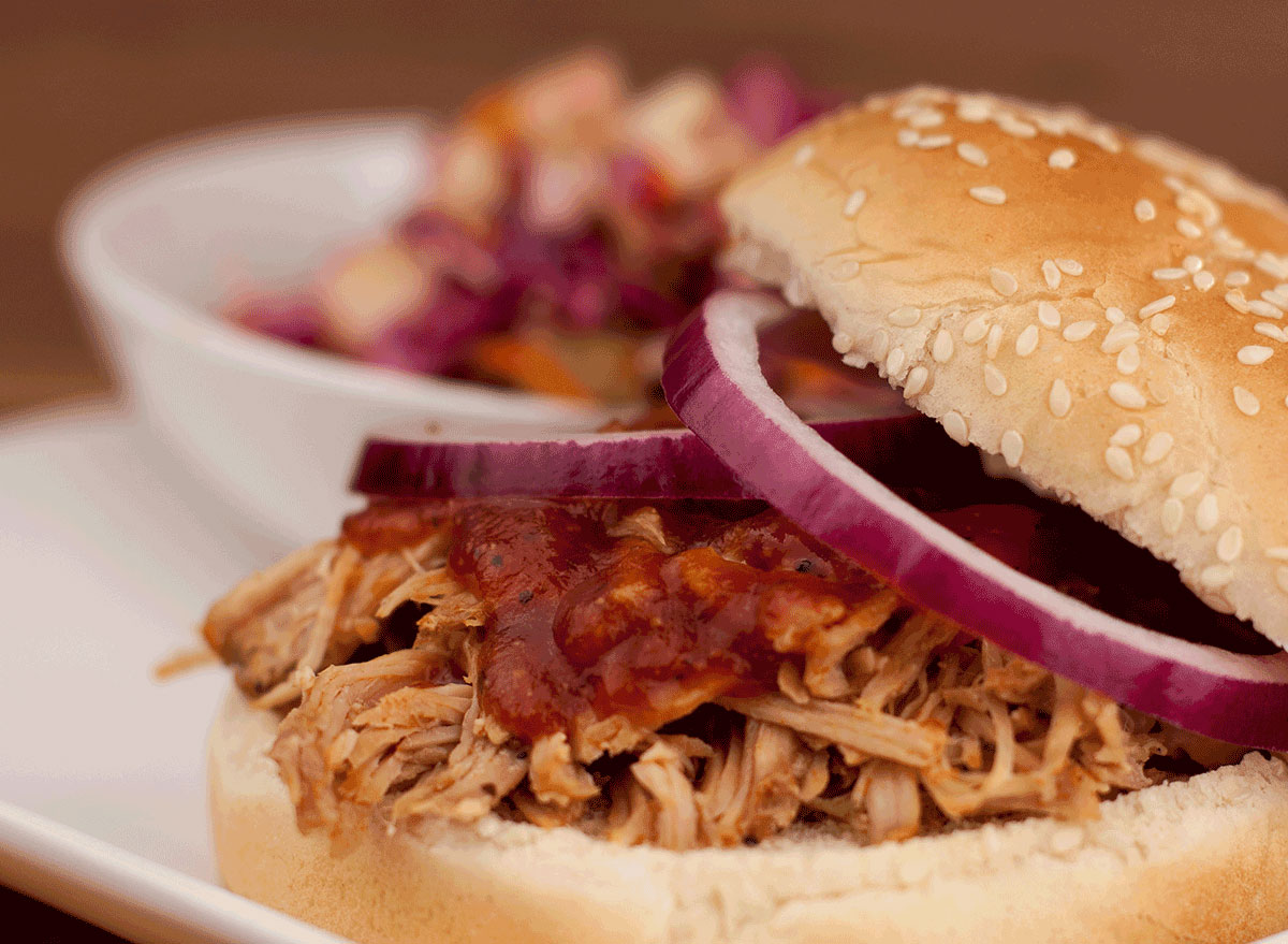 north carolina bbq sandwich with sauce onions on plate