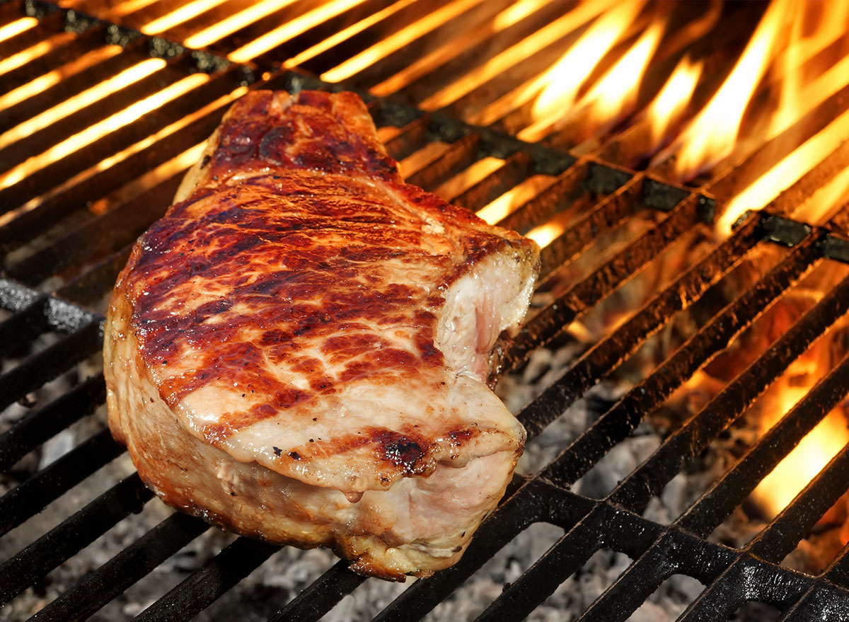 pork chops cooking on grill