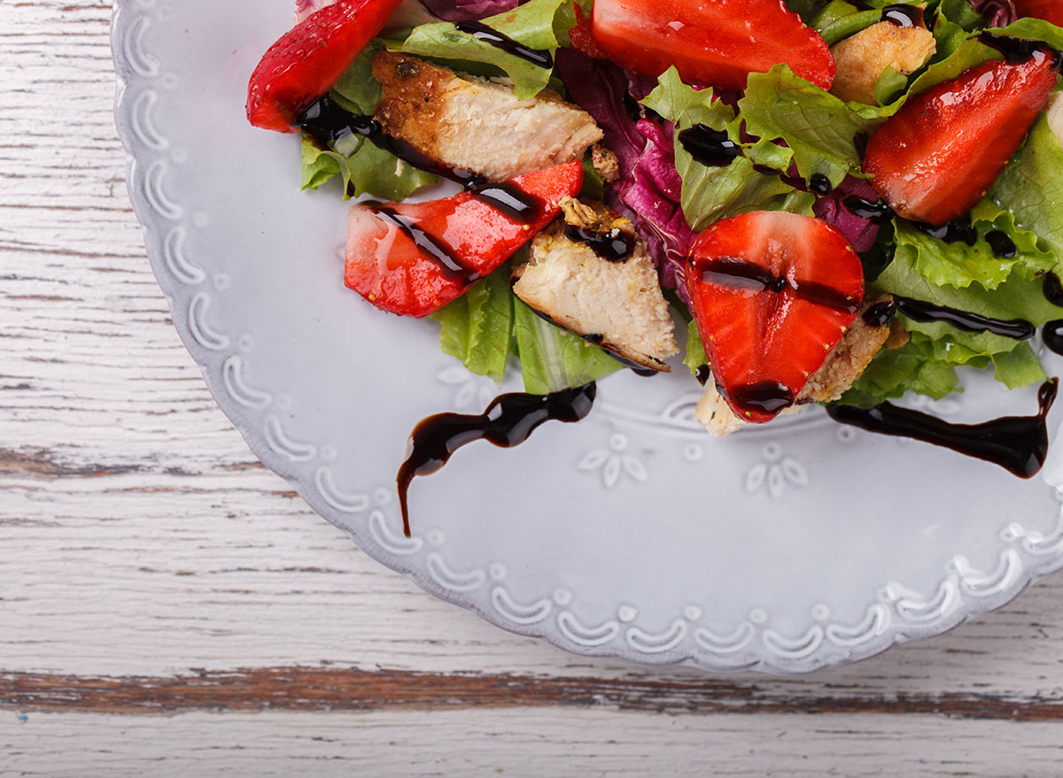 plated salad of lettuce strawberries chicken with balsamic vinaigrette