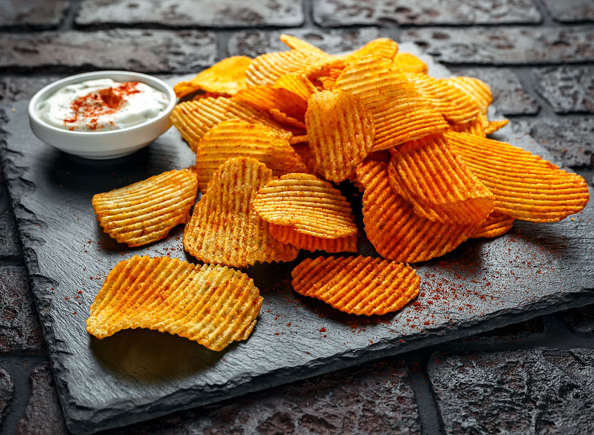 smoked paprika potato chips on black plate with dipping sauce