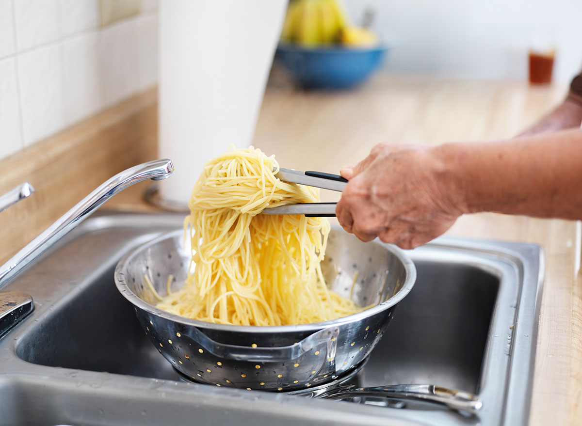 straining pasta in sink