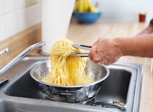 straining pasta in sink