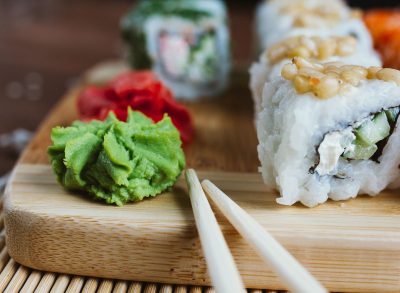 wasabi and sushi on wooden board