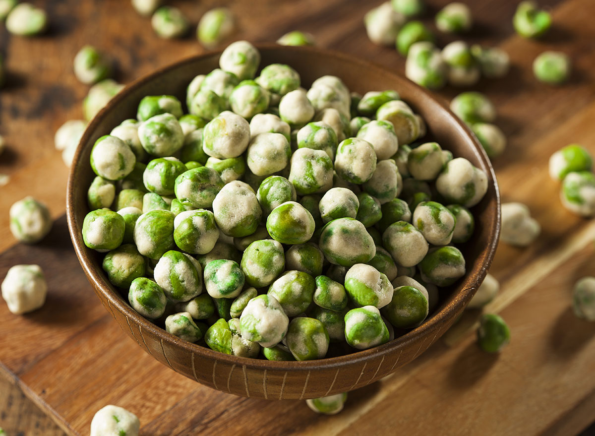 wasabi peas in bowl spilled on table