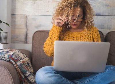 woman sitting at home on laptop