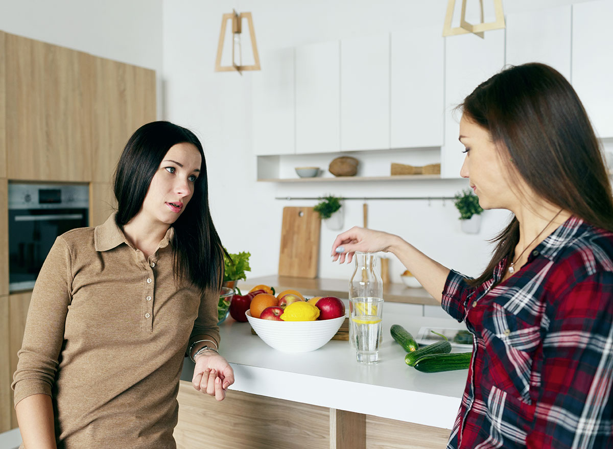 two women talking in kitchen