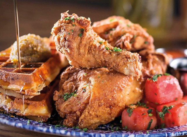 yardbird fried chicken and waffles and watermelon on a blue plate.