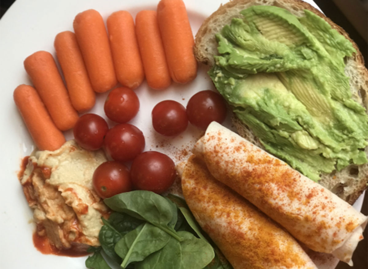 open-faced turkey sandwich roll turmeric cayenne black pepper baby carrots cherry tomatoes hummus organic peasant bread mashed avocado sea salt - what a peloton instructor eats