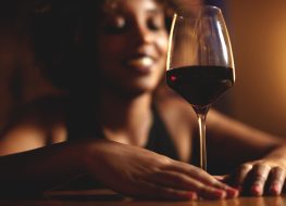 Black woman drinking red wine