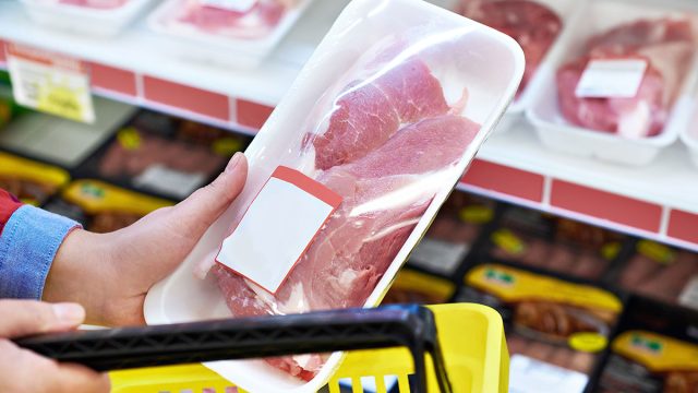 hand buying meat without back at grocery store