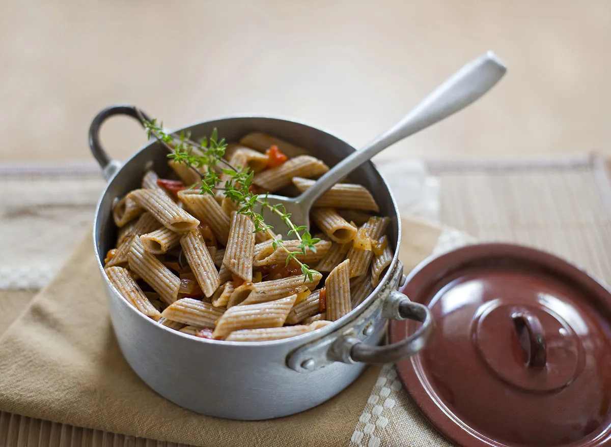 cooked and seasoned whole wheat pasta in pan