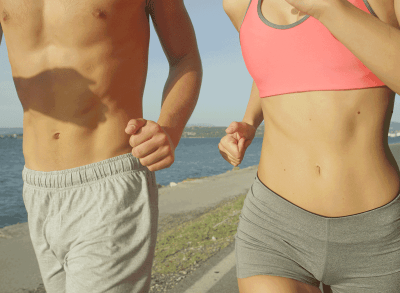 shirtless flat belly couple running on beach