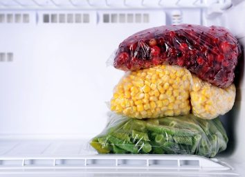 frozen cranberries corn and green beans in an empty freezer