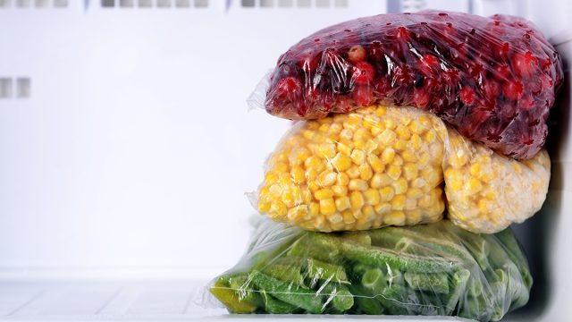 frozen cranberries corn and green beans in an empty freezer