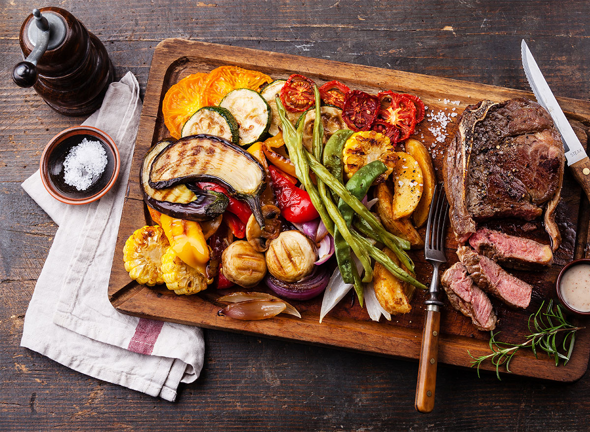 serving platter of grilled steak and vegetables