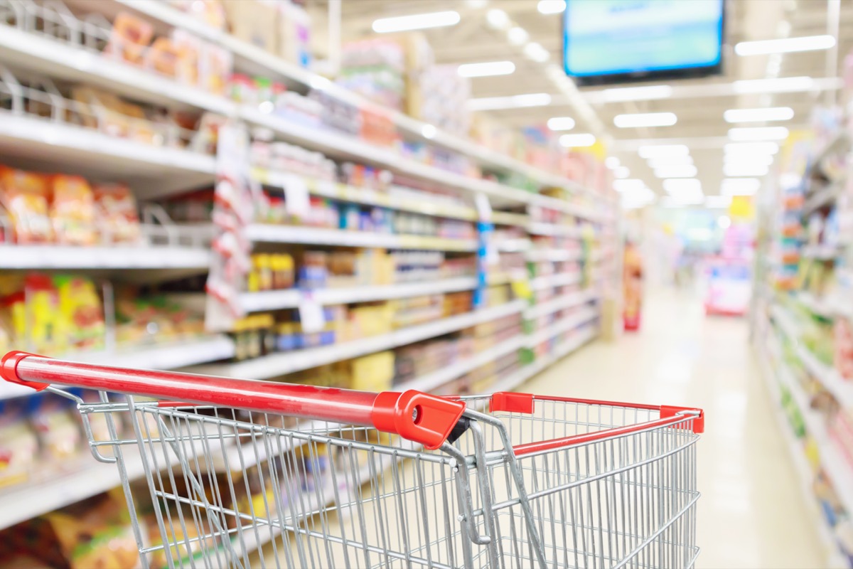 grocery cart in aisle with blurred background