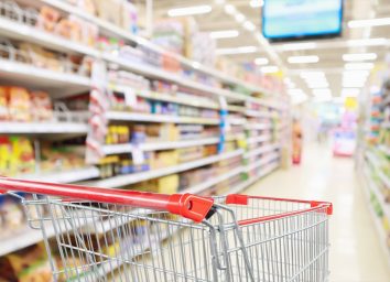 grocery cart in aisle with blurred background