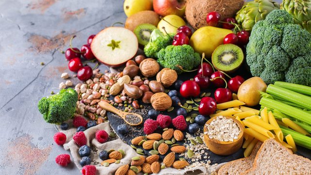 a spread of various vegetables, fruits, nuts and oats