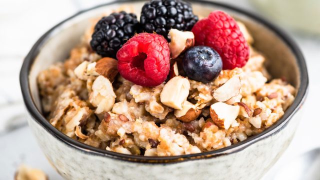 High fiber breakfast whole grain oatmeal with fresh berries nuts and seeds
