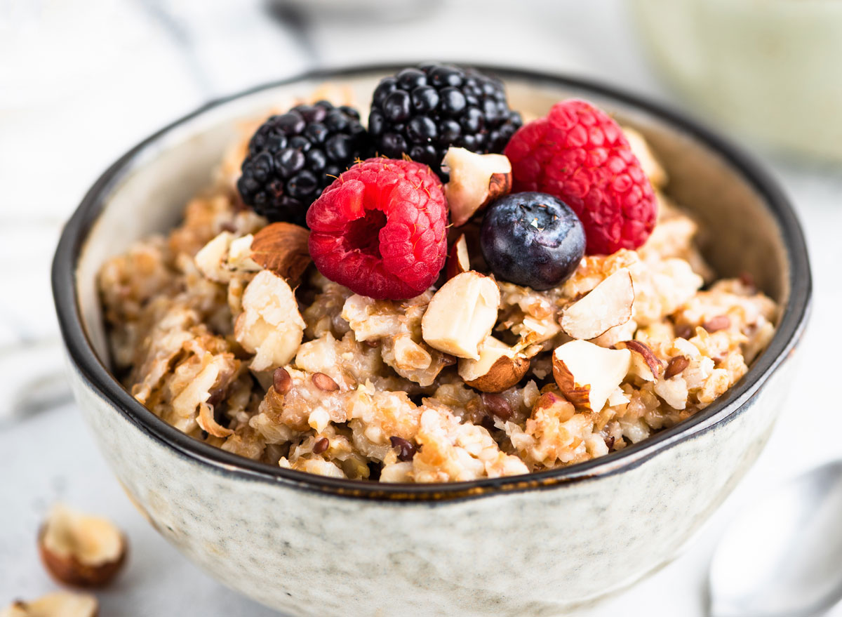 High fiber breakfast whole grain oatmeal with fresh berries nuts and seeds - how to beat weight loss plateau