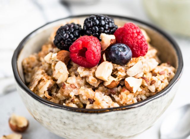High-fiber breakfast wholemeal oatmeal with fresh berries, nuts and seeds
