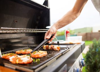 man grilling food outside