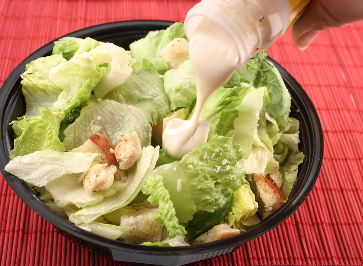 salad in bowl with dressing poured over top