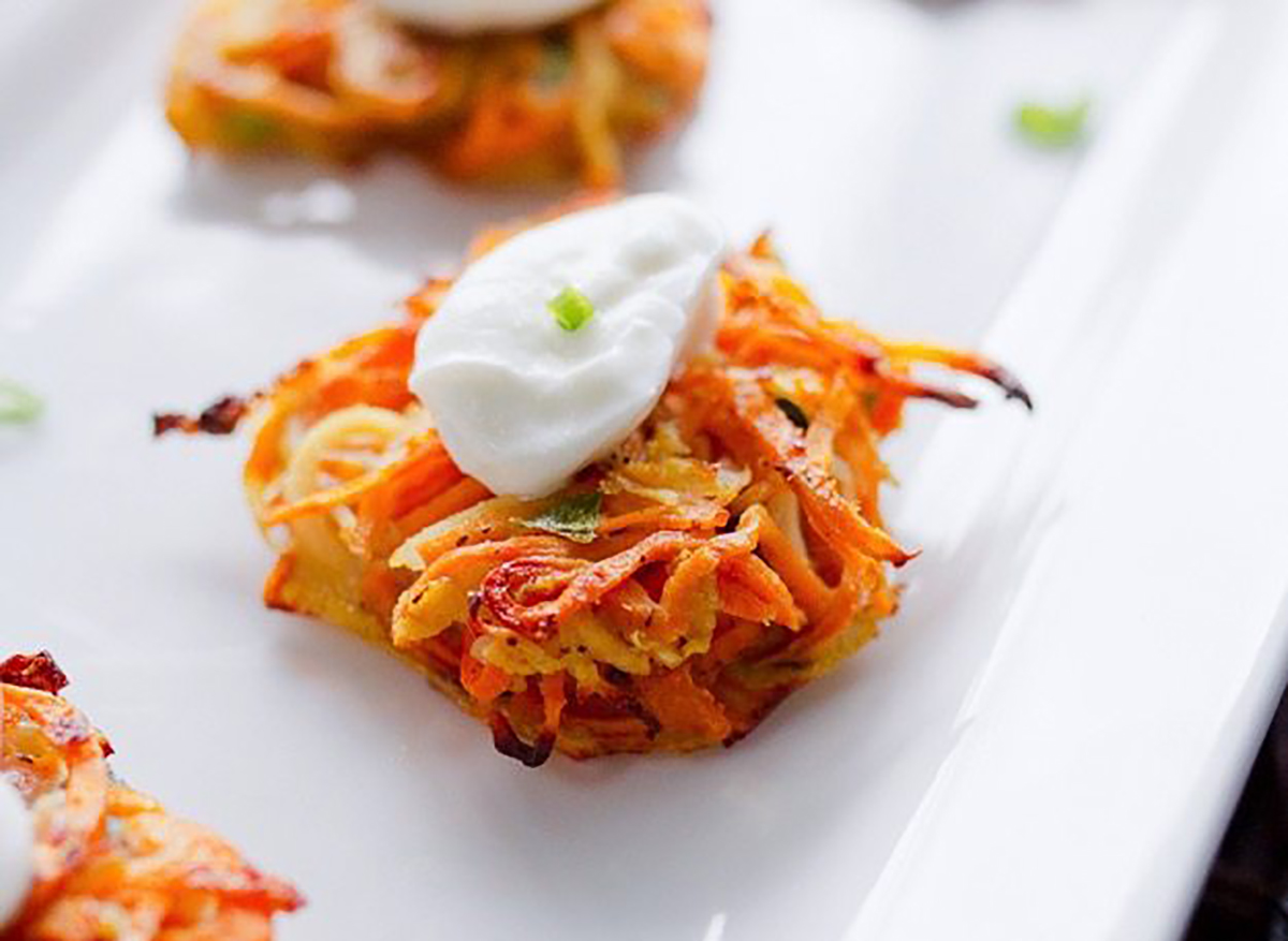 sweet potato and parsnip latke with sour cream and herbs ready on a plate