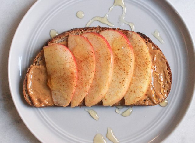 apple peanut butter cinnamon honey toast on grey plate and marble counter