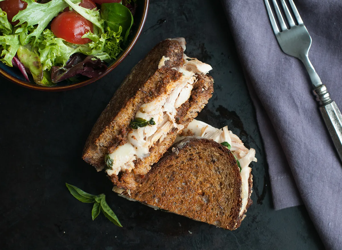 chicken salad sandwich on whole wheat bread with side salad
