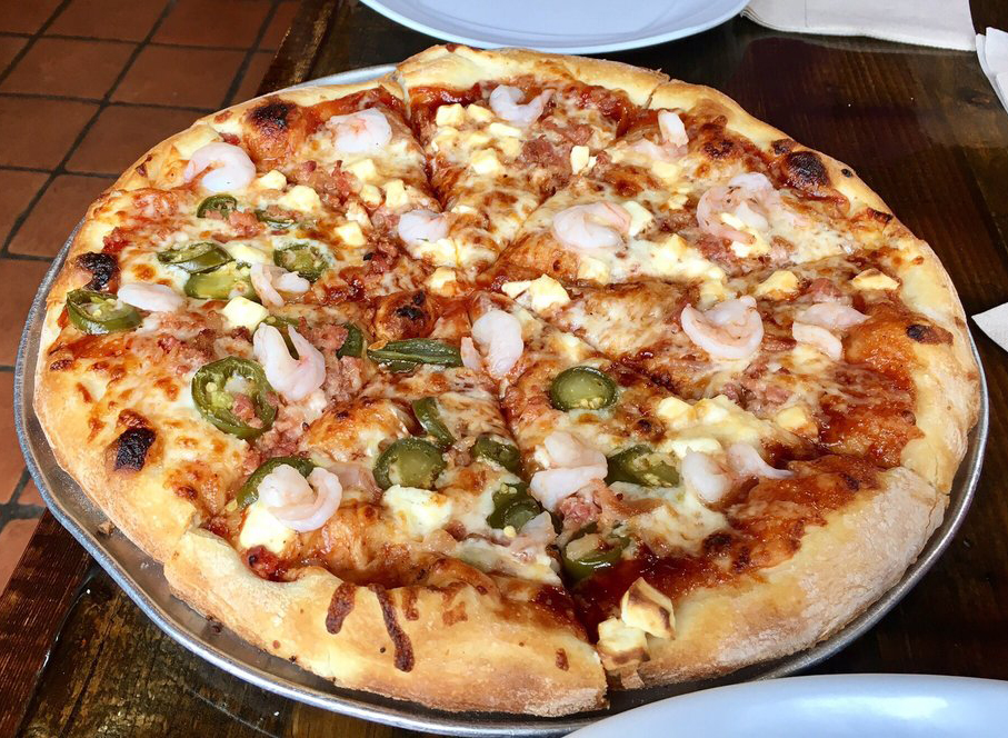 colorado mountain pizza style on a plate with toppings piled on top